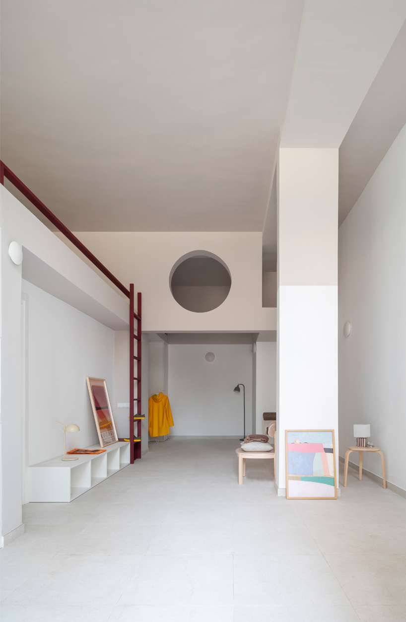 garnet-red accents and high clerestories punctuate AA Apartments in málaga - 1