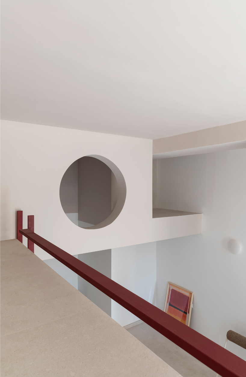 garnet-red accents and high clerestories punctuate AA Apartments in málaga - 11