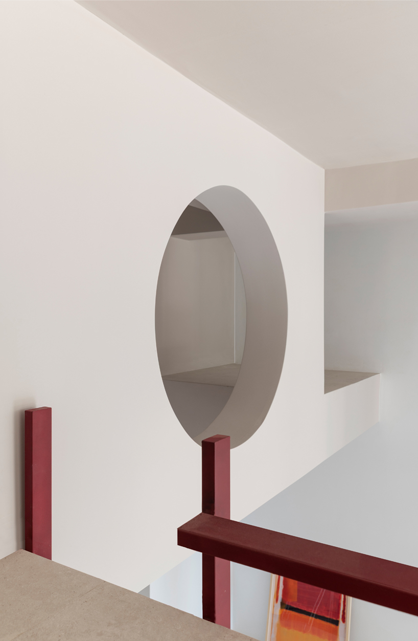 garnet-red accents and high clerestories punctuate AA Apartments in málaga - 12