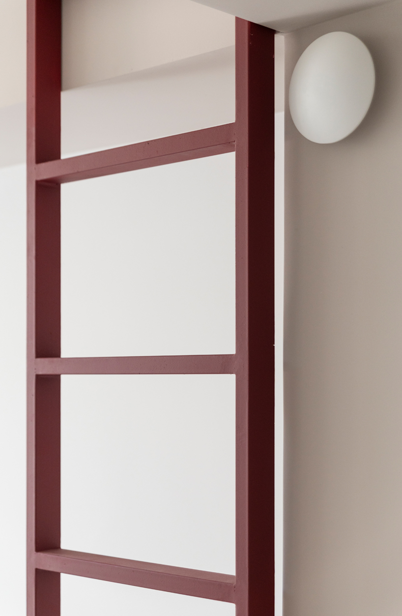 garnet-red accents and high clerestories punctuate AA Apartments in málaga - 13