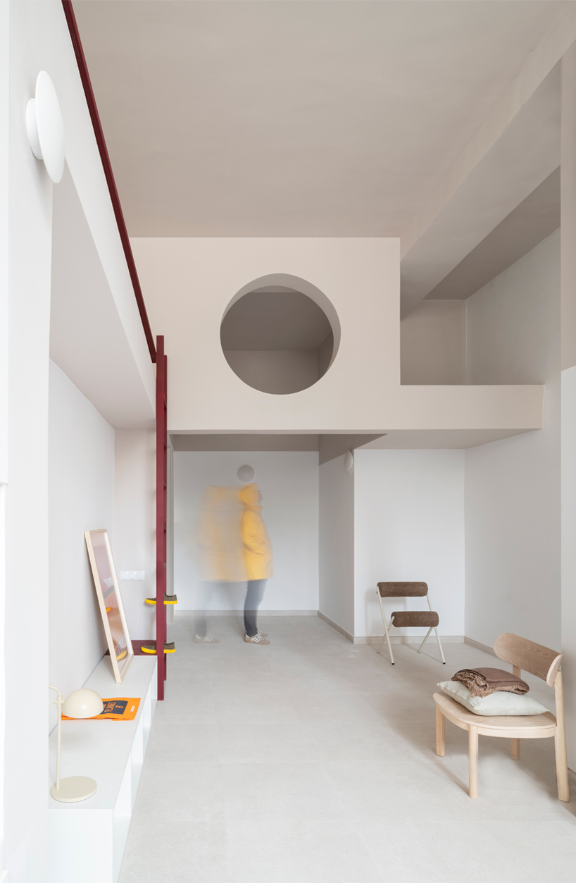 garnet-red accents and high clerestories punctuate AA Apartments in málaga - 2
