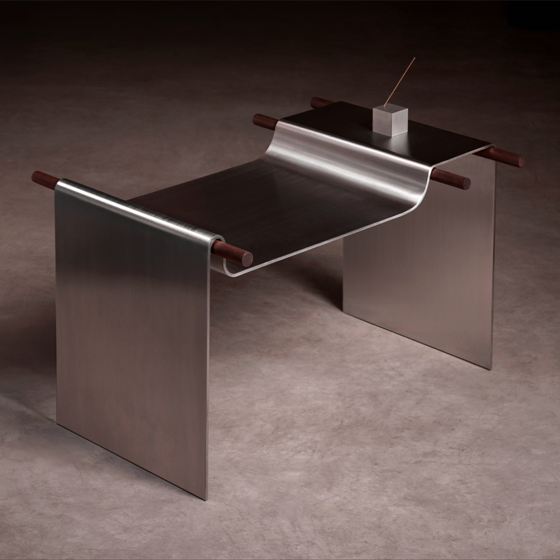 single sheet of steel drapes like fabric over wooden rods to form parchment stool