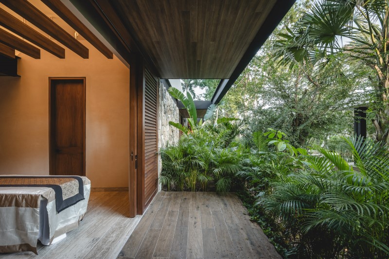 lush vegetation and stone walls enclose taller mexicano de arquitectura's hotel spa in mexico