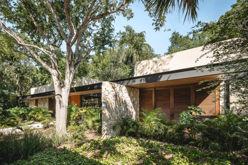 lush vegetation and stone walls enclose taller mexicano de arquitectura's hotel spa in mexico