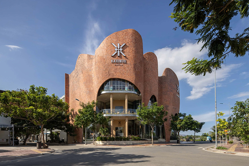 fluid brick-clad facade undulates around karinox coffee shop in vietnam