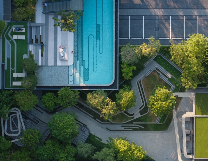 fingerprint patterns inform sculptural landscape design within bangkok housing complex