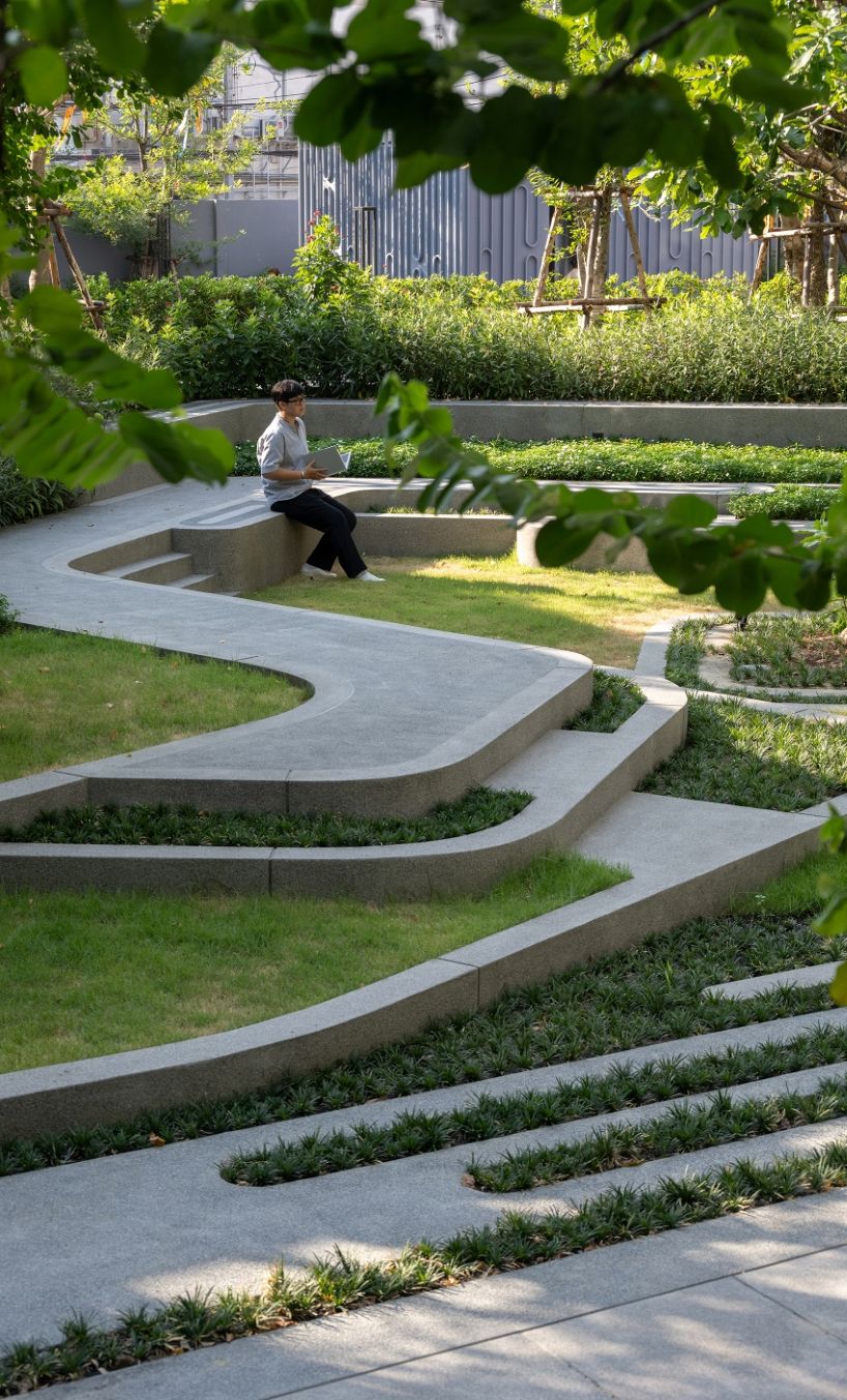 fingerprint patterns inform sculptural landscape design within bangkok housing complex
