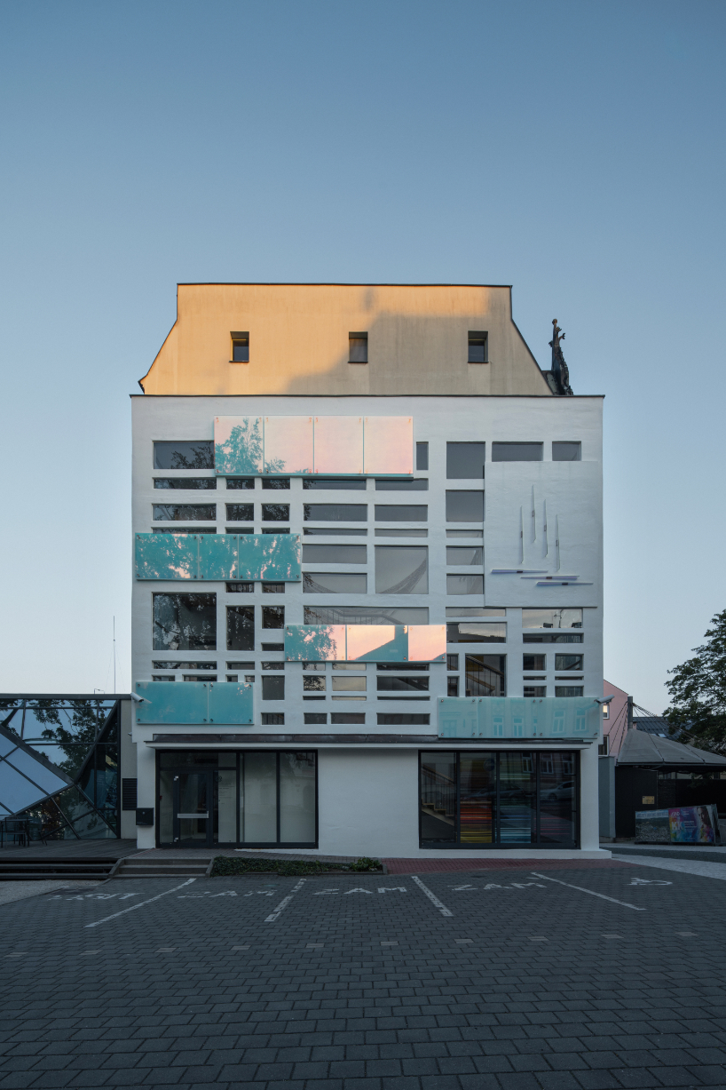 dichroic glass collage by tereza šváchová wraps museum staircase in czech republic