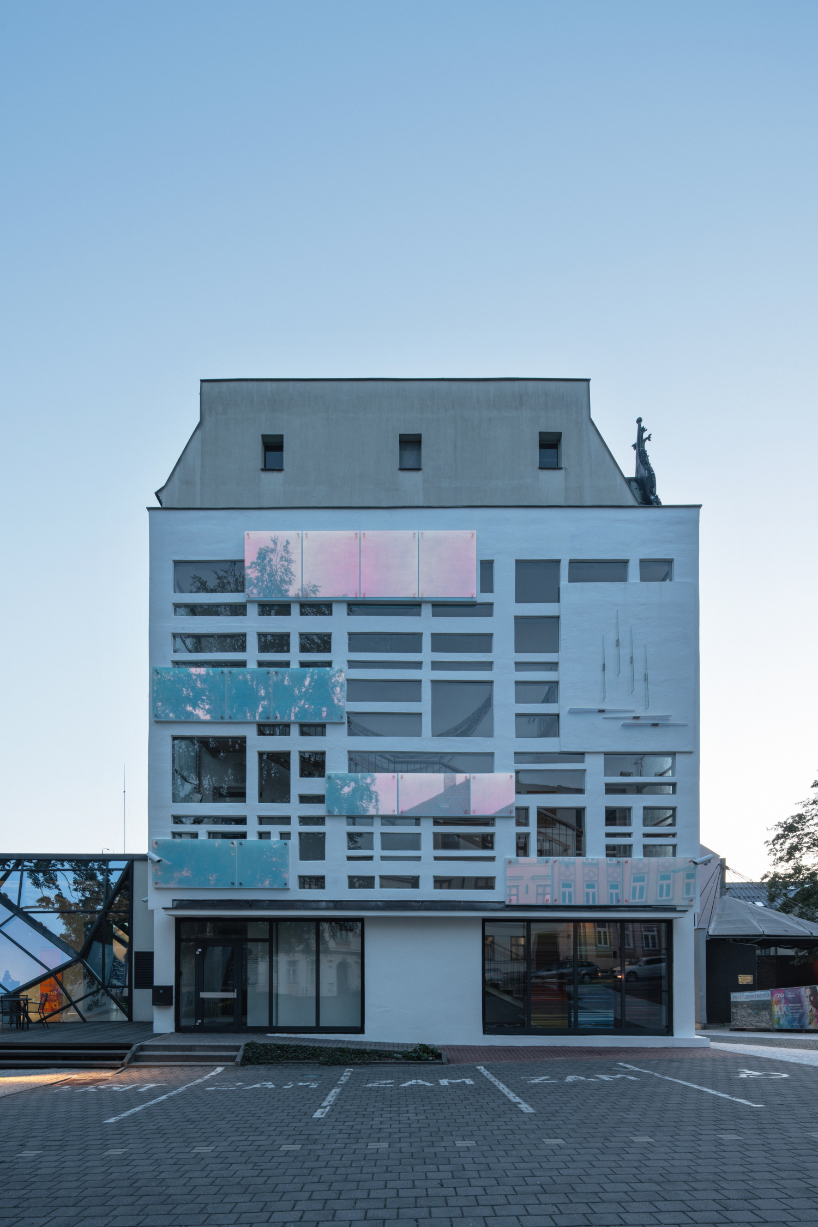 dichroic glass collage by tereza šváchová wraps museum staircase in czech republic