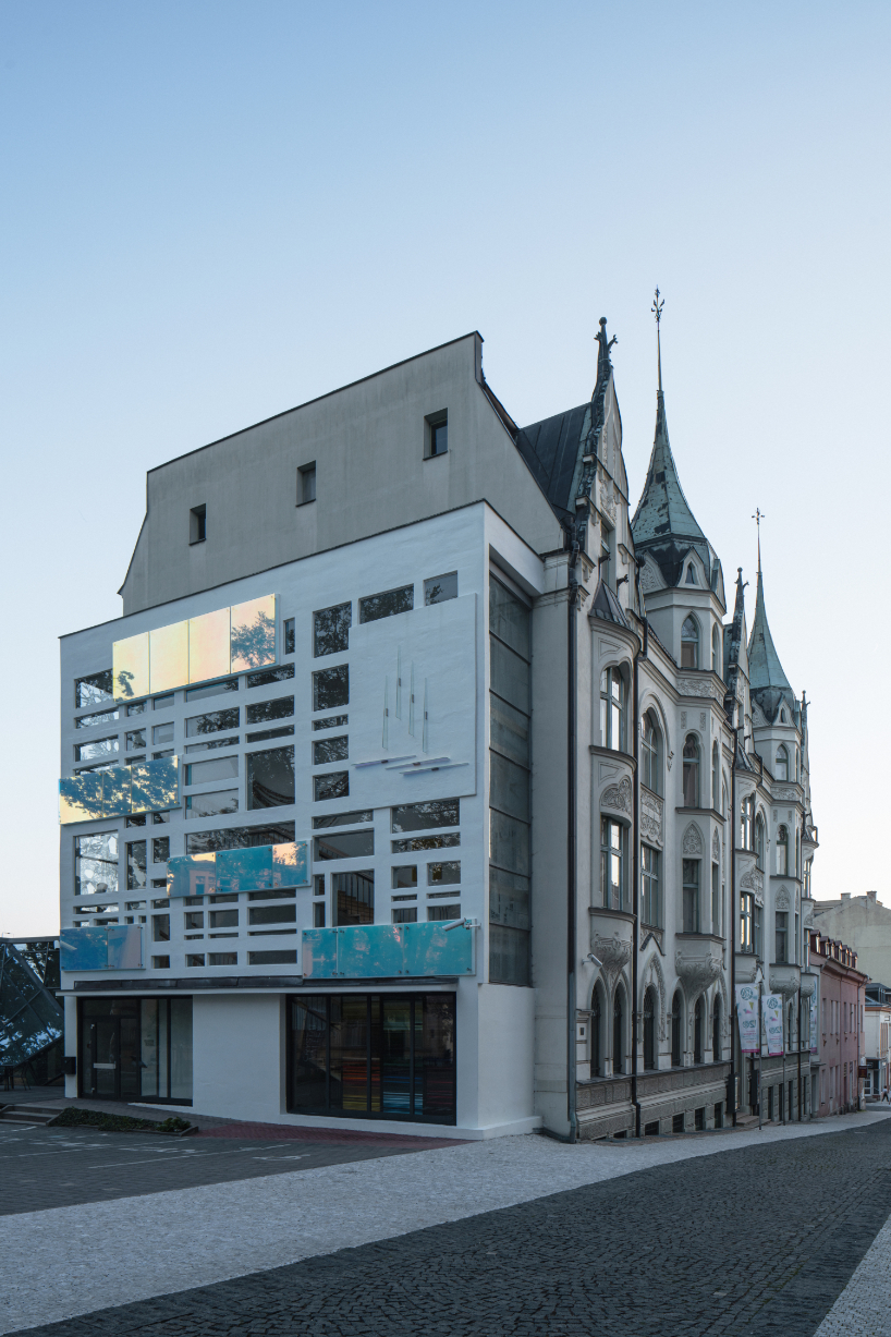 dichroic glass collage by tereza šváchová wraps museum staircase in czech republic