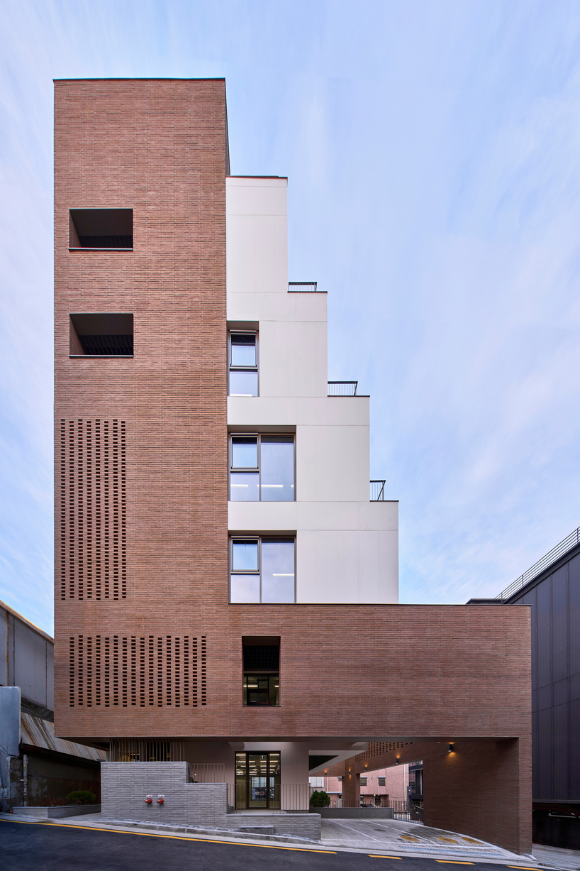 stepped facade extended from brick base in mixed-use building by mlnp architects in Seoul