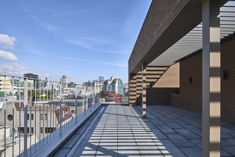 stepped facade extended from brick base in mixed-use building by mlnp architects in Seoul