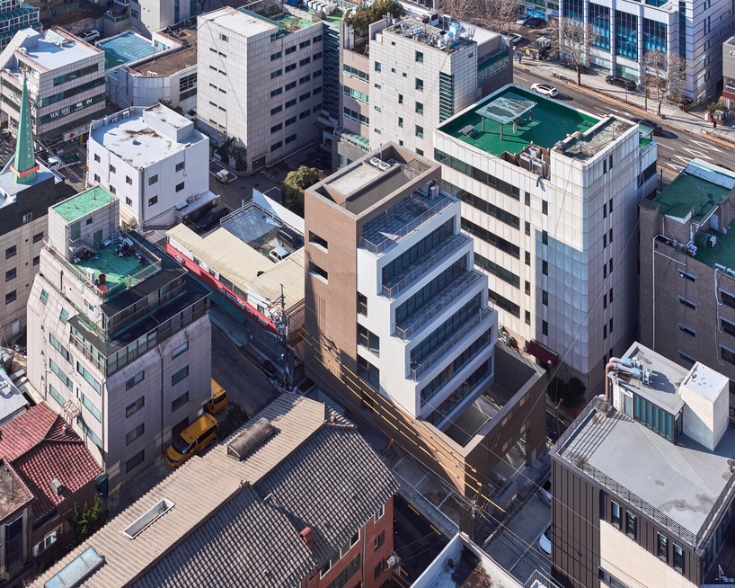 stepped facade extended from brick base in mixed-use building by mlnp architects in Seoul