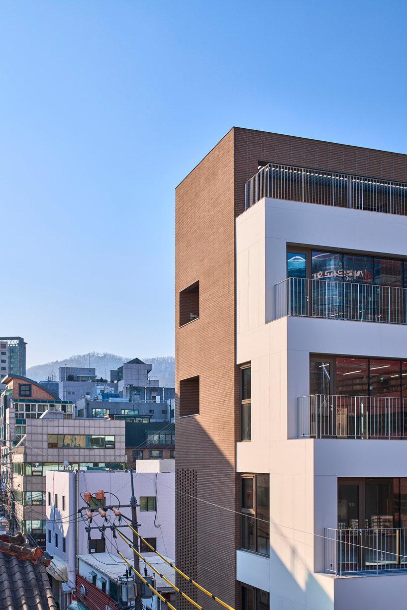 stepped facade extended from brick base in mixed-use building by mlnp architects in Seoul