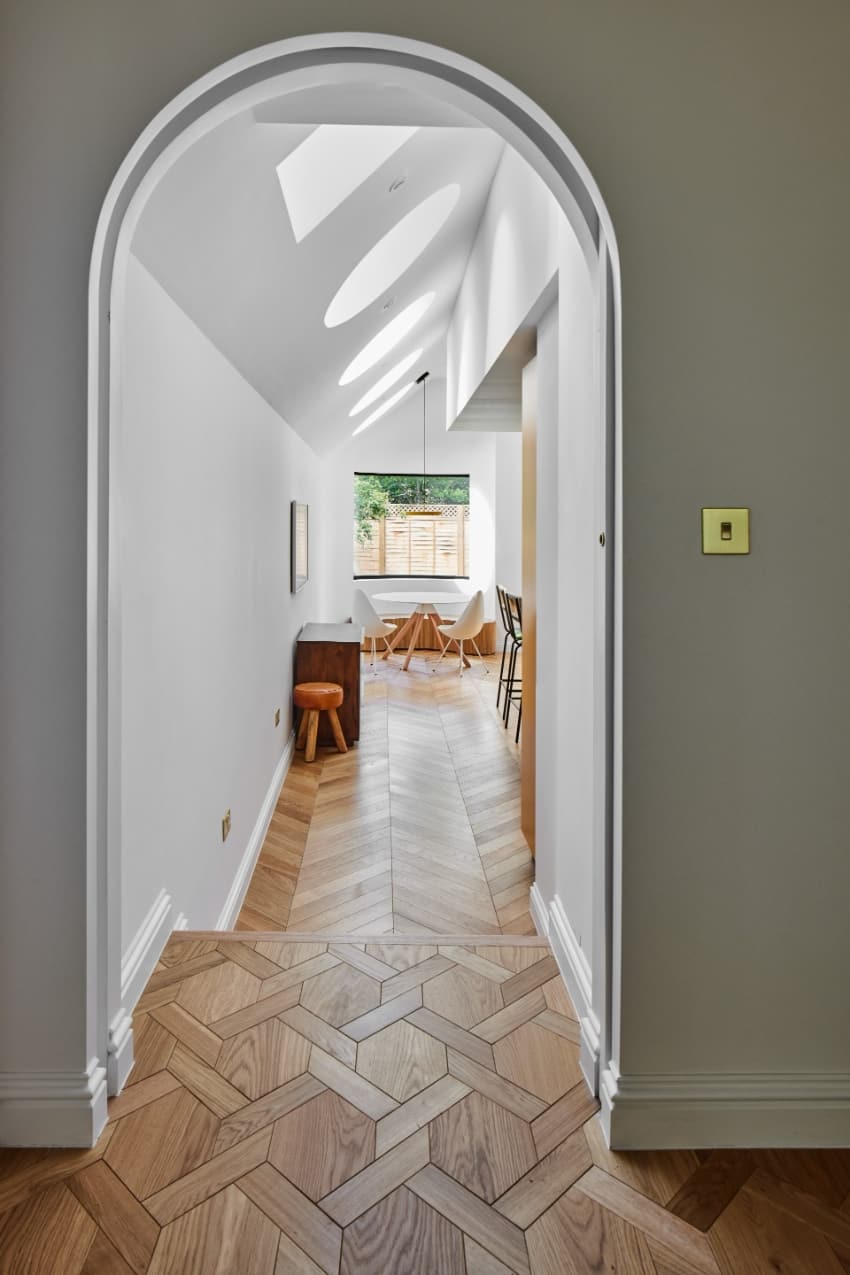 a series of square and circular skylights introduces geometric light casts within minty house