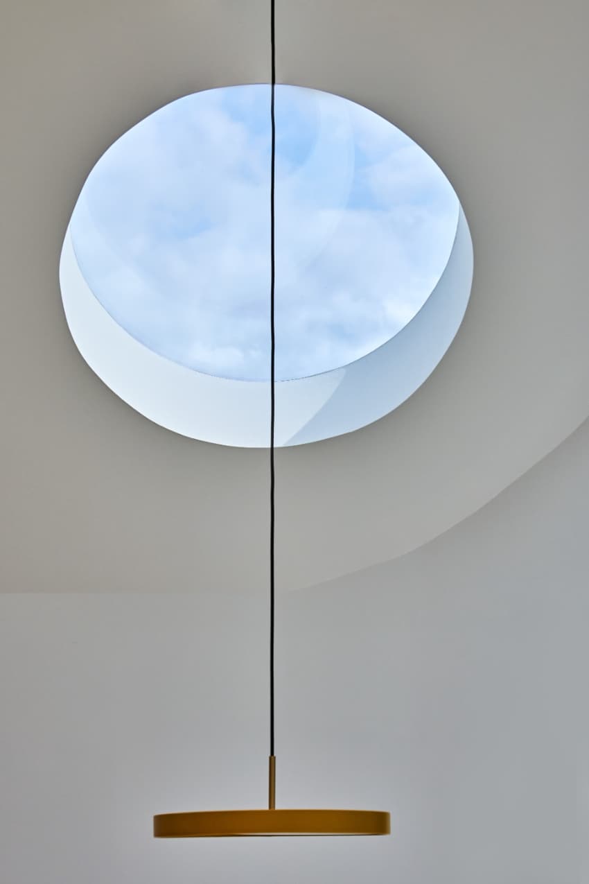 a series of square and circular skylights introduces geometric light casts within minty house