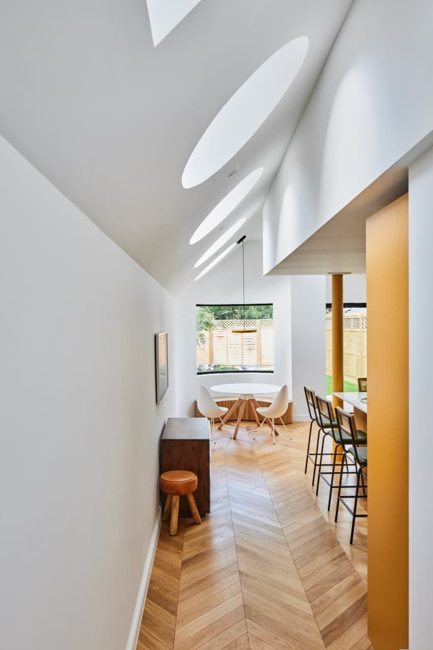 a series of square and circular skylights introduces geometric light casts within minty house