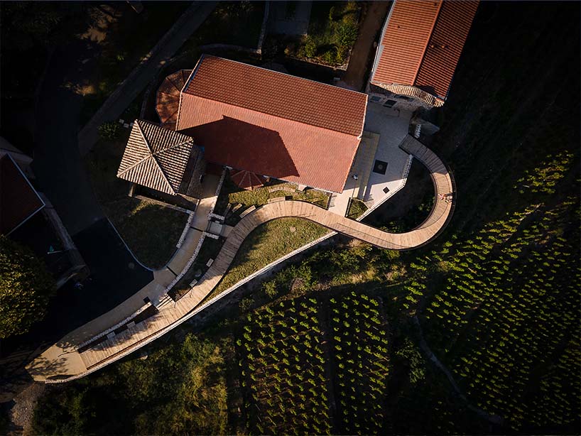 belvedere's wooden promenade by collection architectes floats above vineyards in france