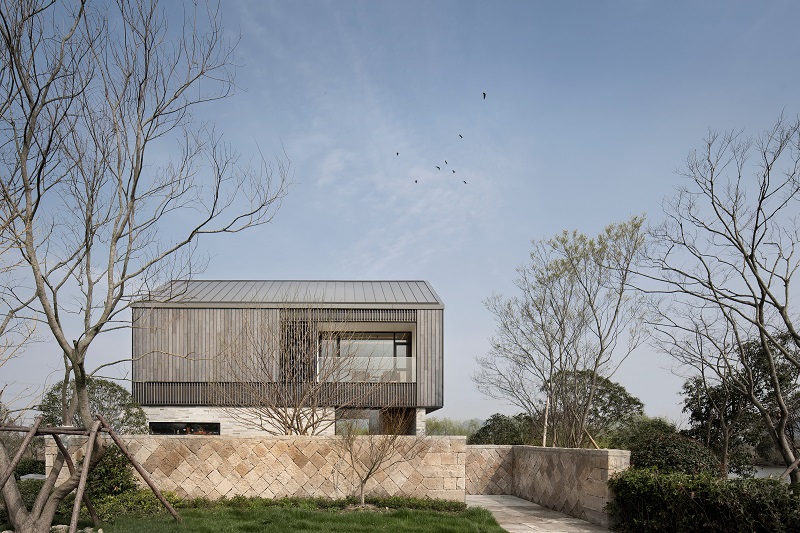 yakisugi wood and stone scraps wrap levels of urbanfabric design's cabin in china wetlands