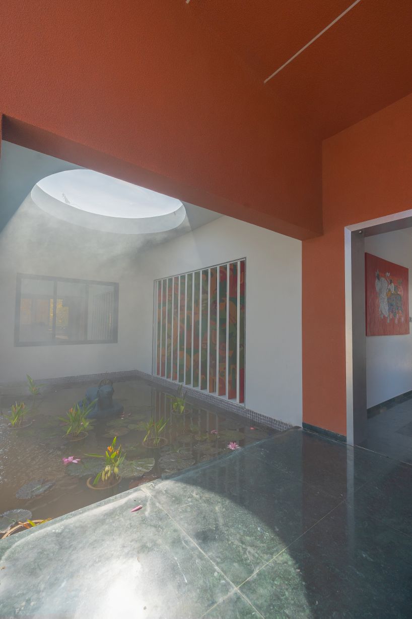 linear, unbroken wall encloses weekend villa by maanchitra in rural india