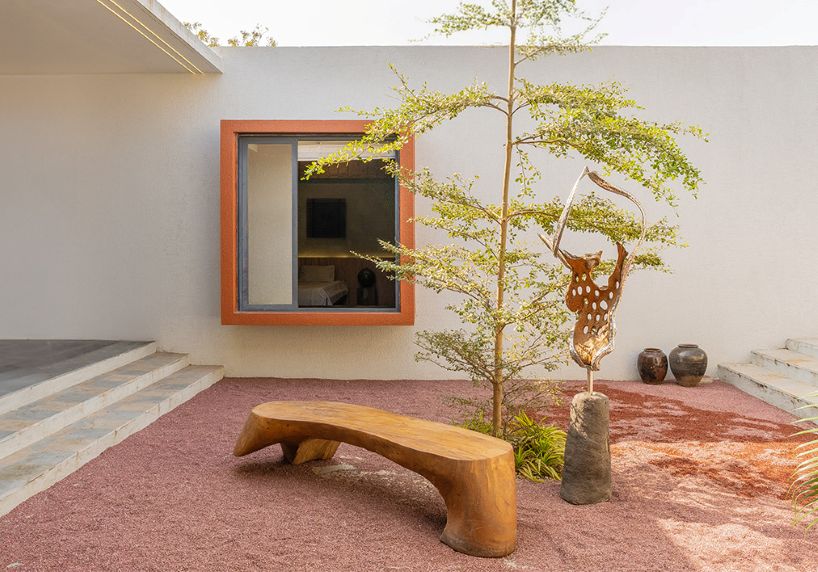 linear, unbroken wall encloses weekend villa by maanchitra in rural india