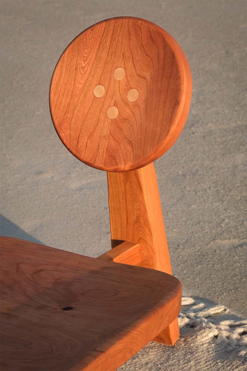 organic contours and asymmetric forms carved from cherry and maple wood define buttonback chair by nush wadia