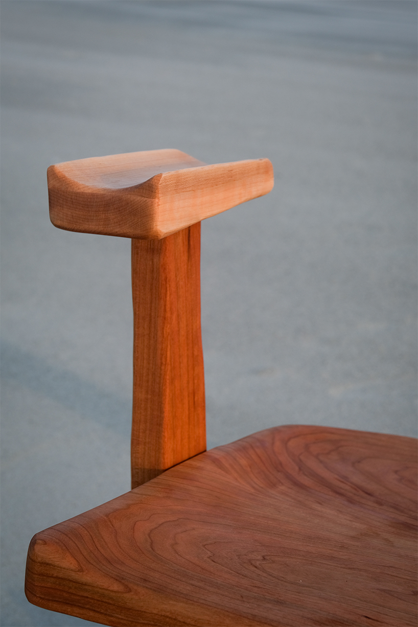 organic contours and asymmetric forms carved from cherry and maple wood define buttonback chair