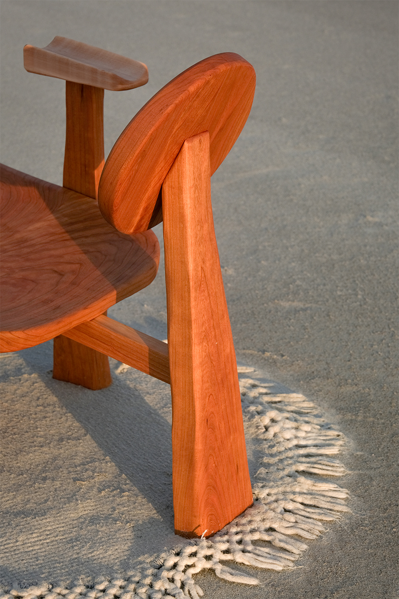 organic contours and asymmetric forms carved from cherry and maple wood define buttonback chair by nush wadia