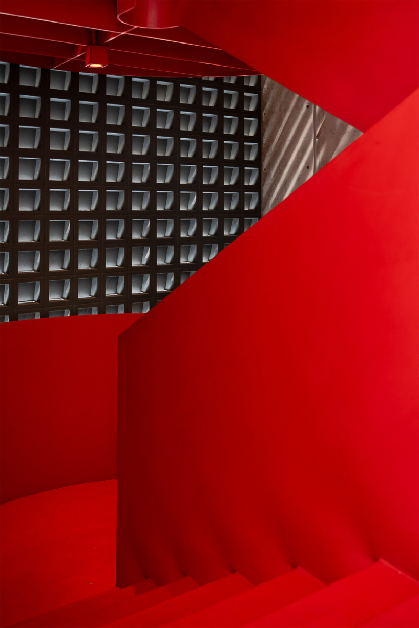 green courtyard anchors hybrid home and office within concrete structure in bangkok