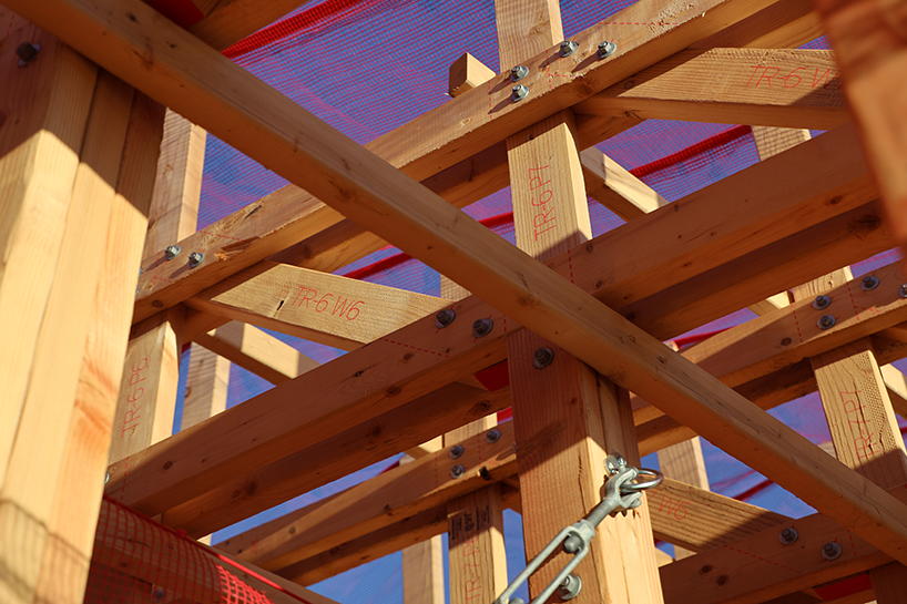 red mesh drapes over wooden curtain call pavilion by office office in woodstock's grounds