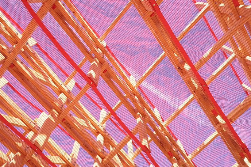 red mesh drapes over wooden curtain call pavilion by office office in woodstock's grounds