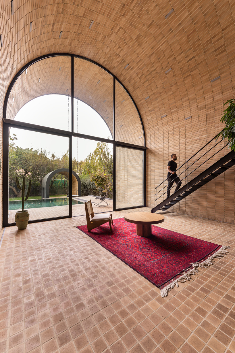 semi-enclosed vaulted residence by super void space splits across narrow water body in iran