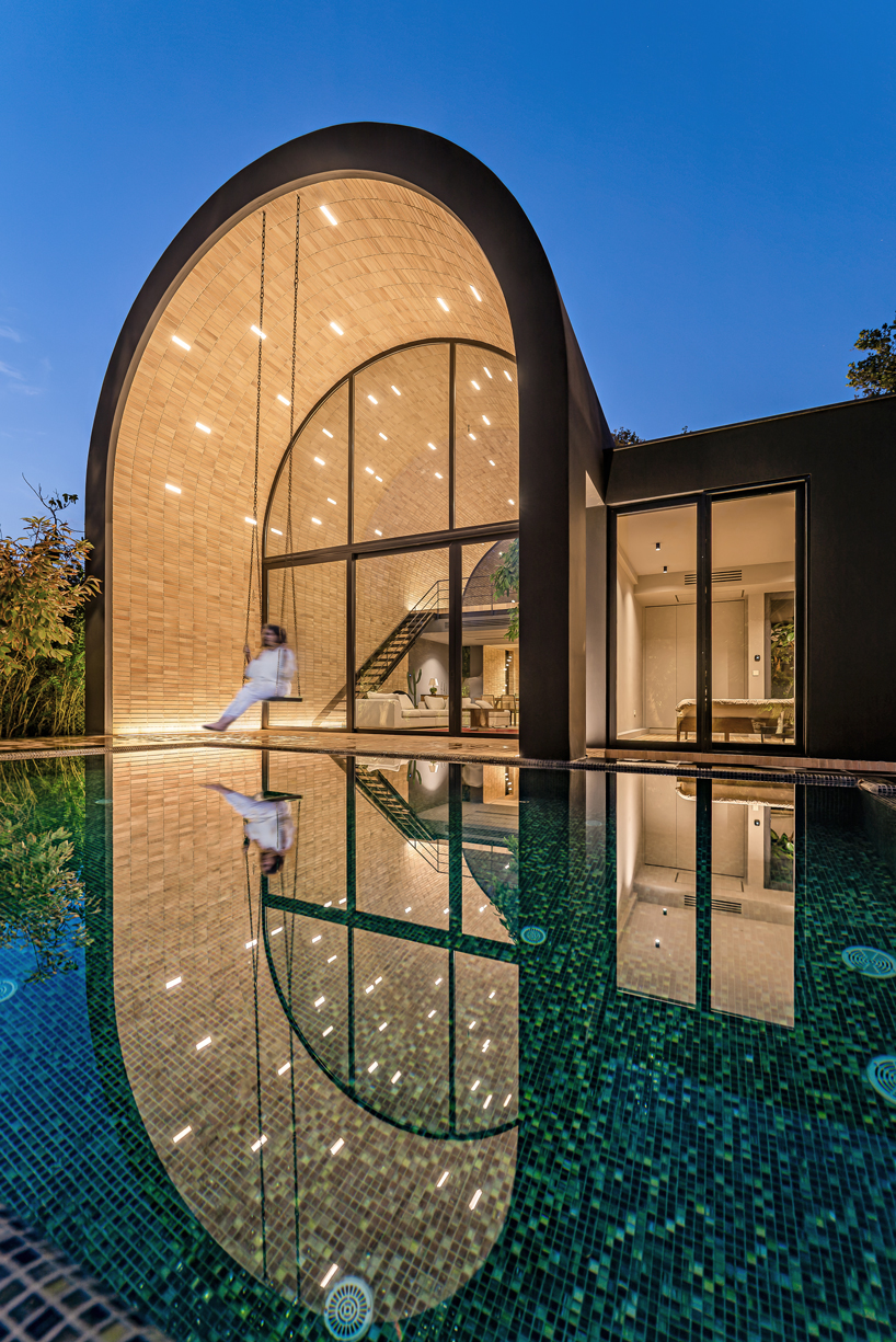 semi-enclosed vaulted residence by super void space splits across narrow water body in iran