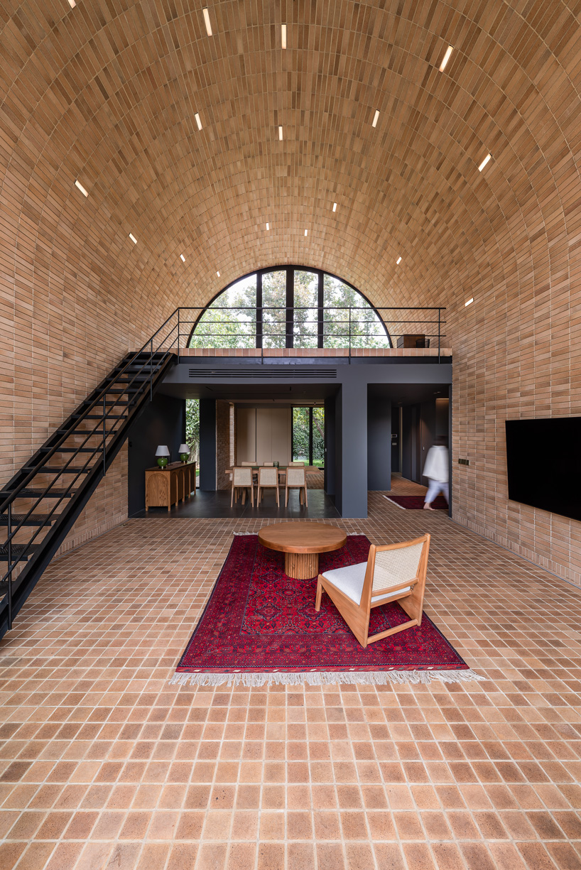 semi-enclosed vaulted residence by super void space splits across narrow water body in iran