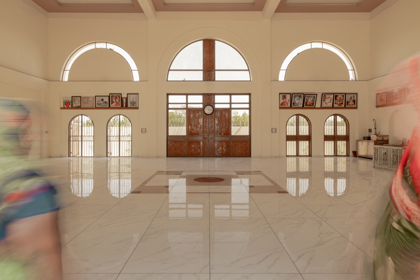 arches carve into ivory-colored walls of raasa architects' ashram in indian village