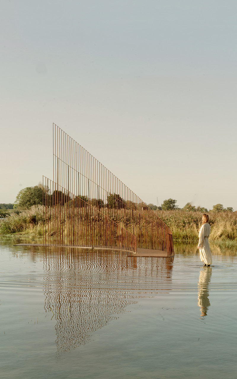 hundreds of vertical untreated steel rebars shape maetherea's kinetic installation in the UK
