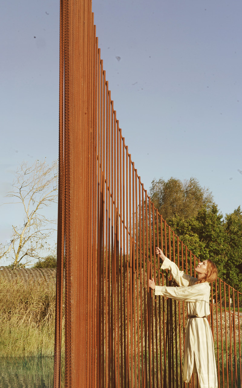 hundreds of vertical untreated steel rebars shape maetherea's kinetic installation in the UK