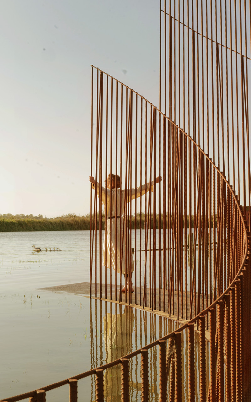 hundreds of vertical untreated steel rebars shape maetherea's kinetic installation in the UK