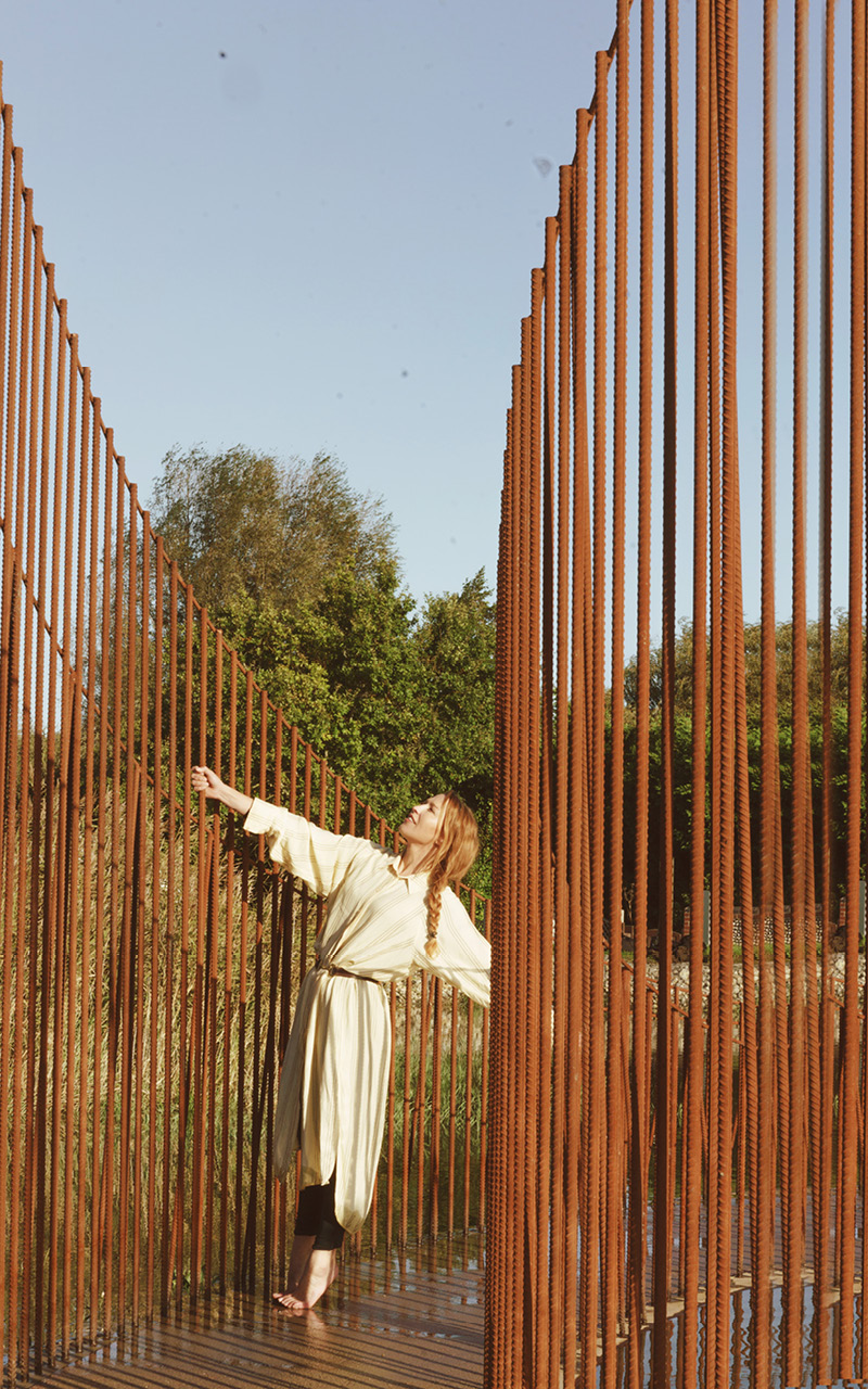 hundreds of vertical untreated steel rebars shape maetherea's kinetic installation in the UK