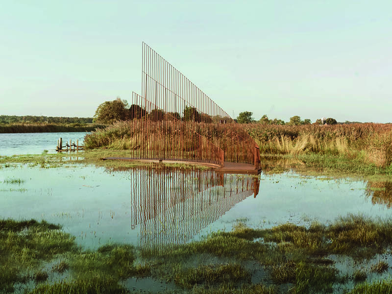 hundreds of vertical untreated steel rebars shape maetherea's kinetic installation in the UK