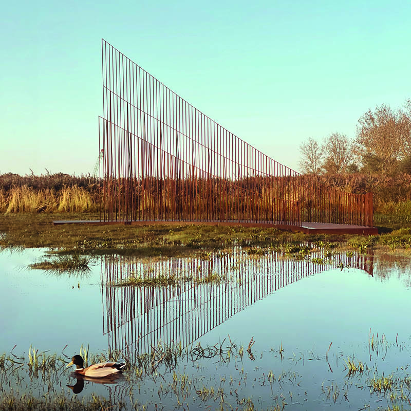 hundreds of vertical untreated steel rebars shape maetherea's kinetic installation in the UK