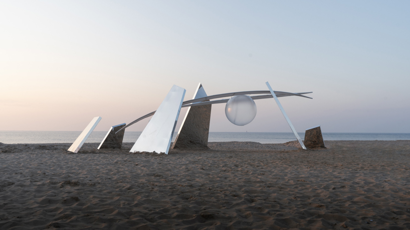 two suspended white wings float around luminous central sphere for oas/s-nest installation