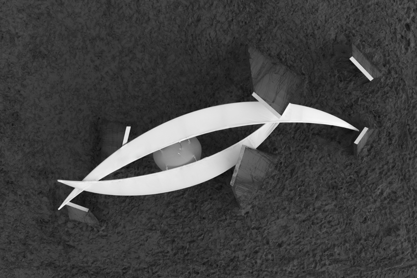 two suspended white wings float around luminous central sphere for oas/s-nest installation