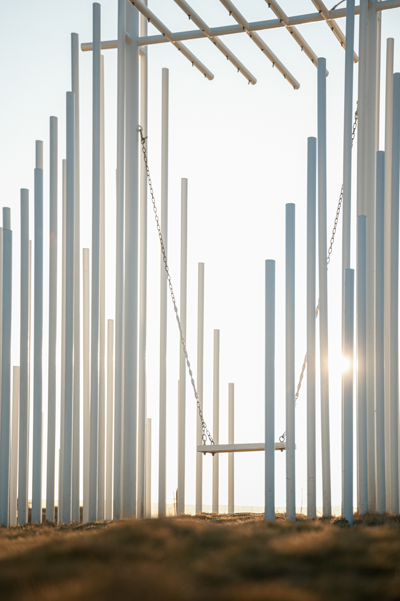 forest of steel pillars creates swinging installation enveloped in cloud-like mist in china