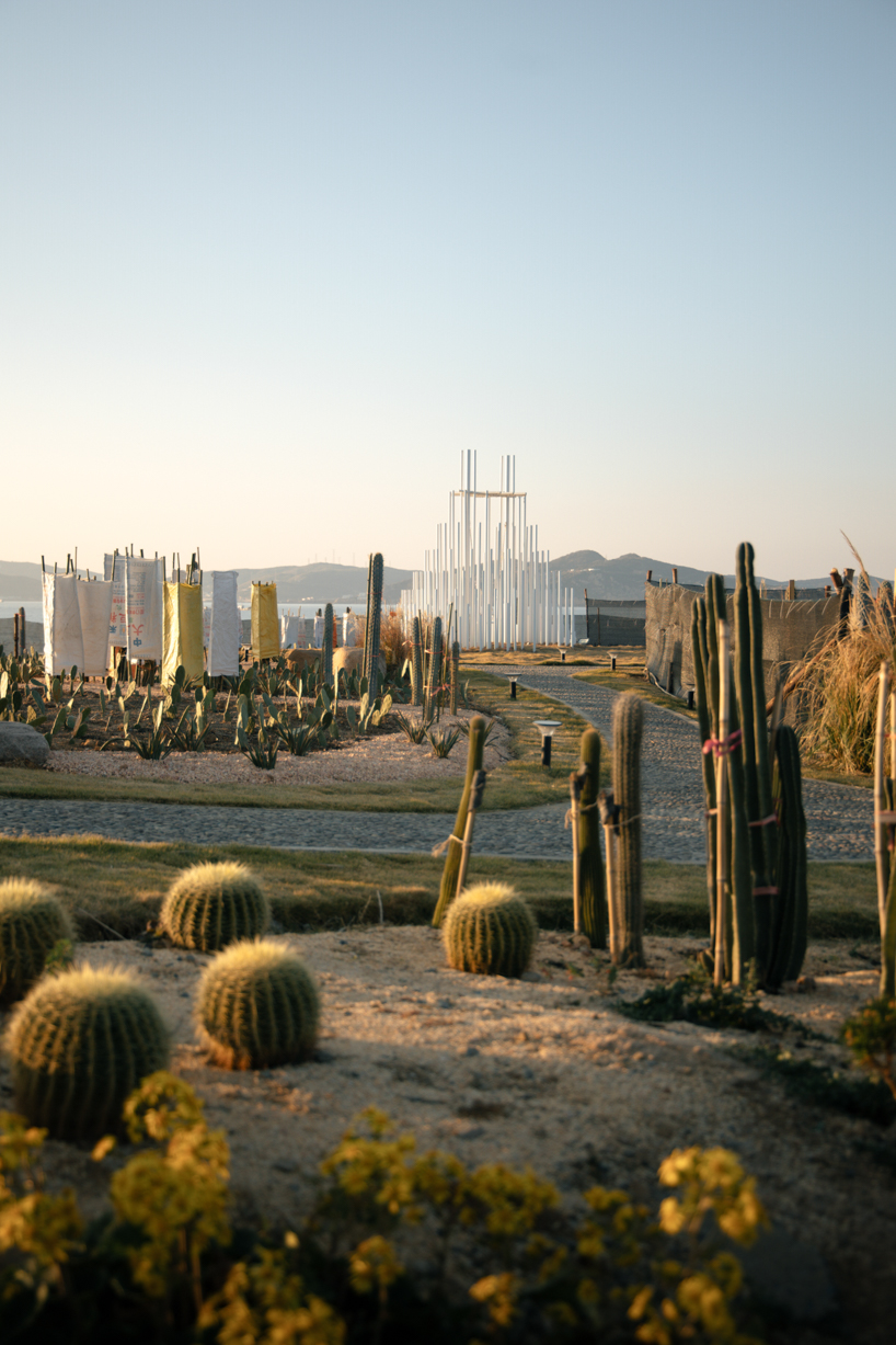 forest of steel pillars creates swinging installation enveloped in cloud-like mist in china