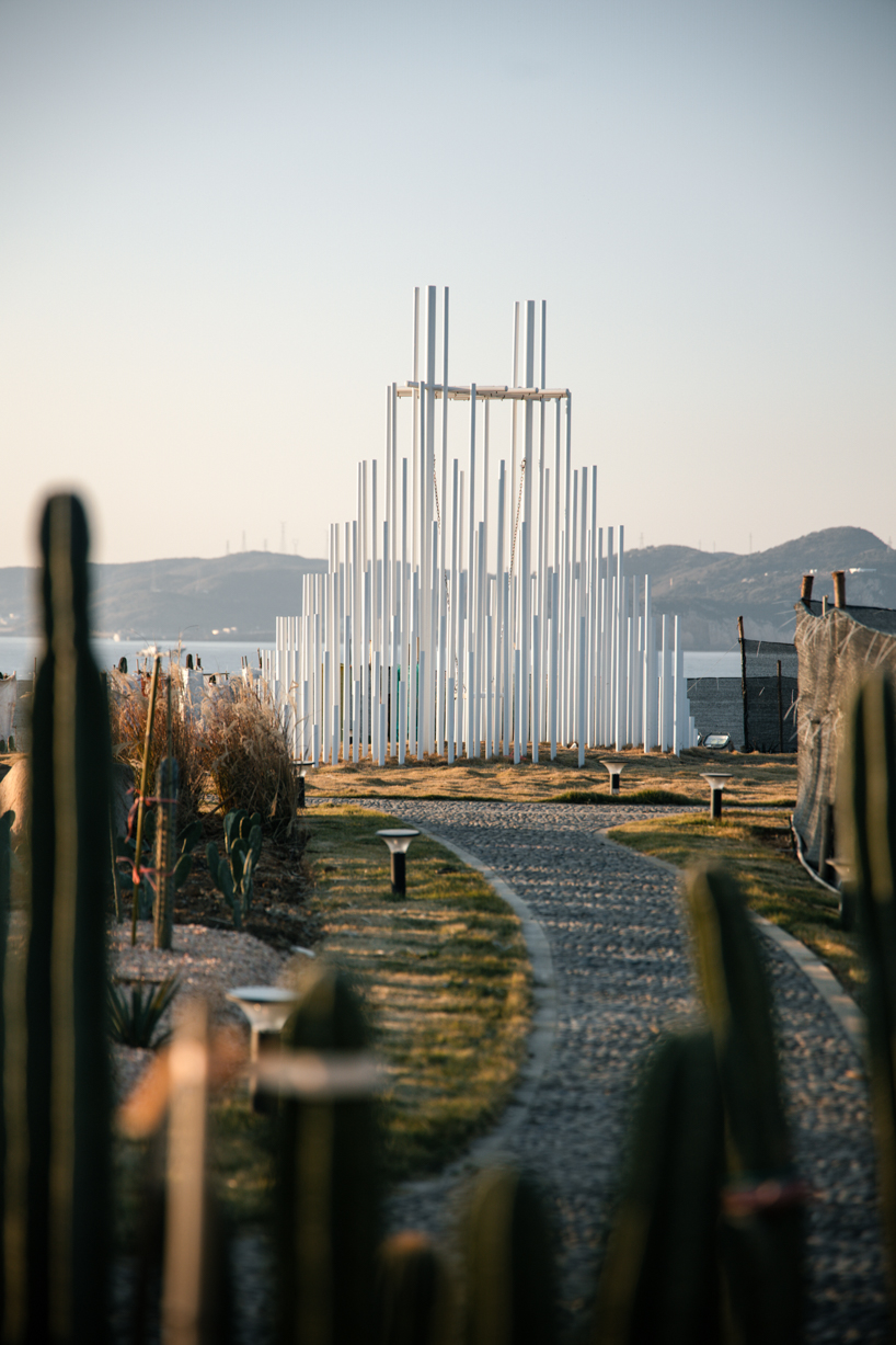 forest of steel pillars creates swinging installation enveloped in cloud-like mist in china