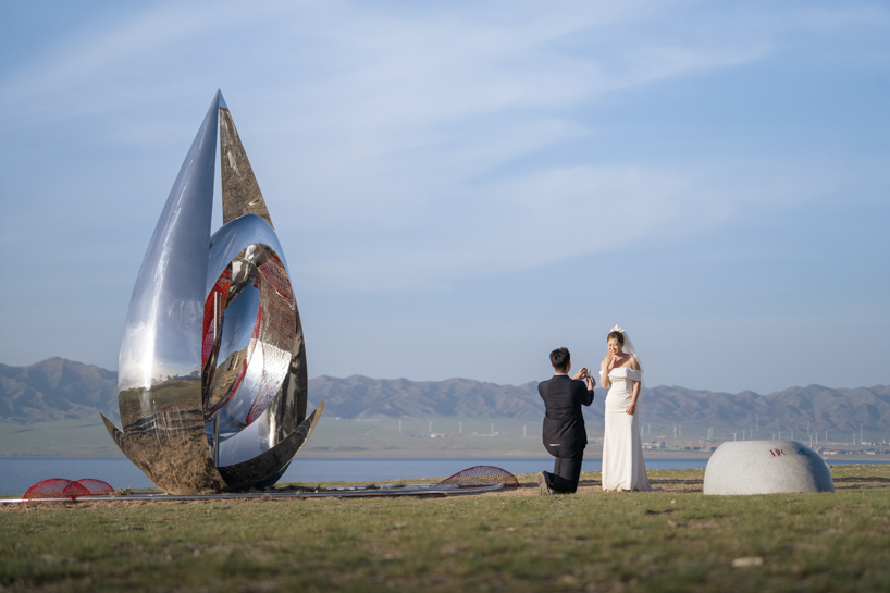 a mirrored water drop installation reflects the landscape of sayram lake in china - 6