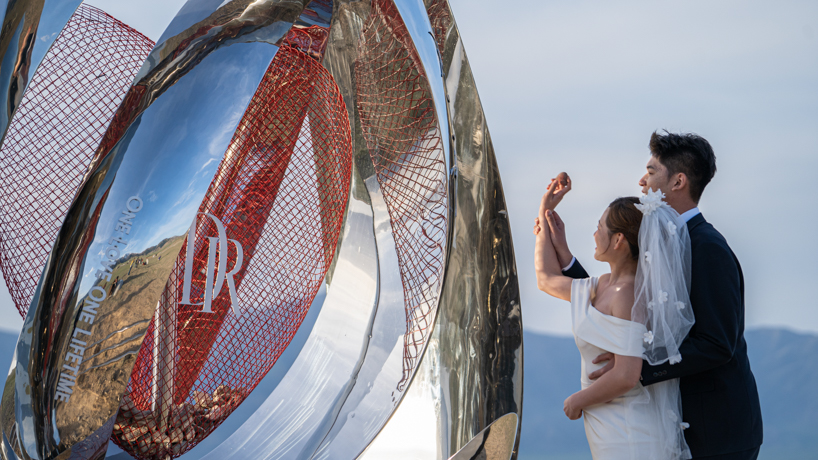 a mirrored water drop installation reflects the landscape of sayram lake in china - 7