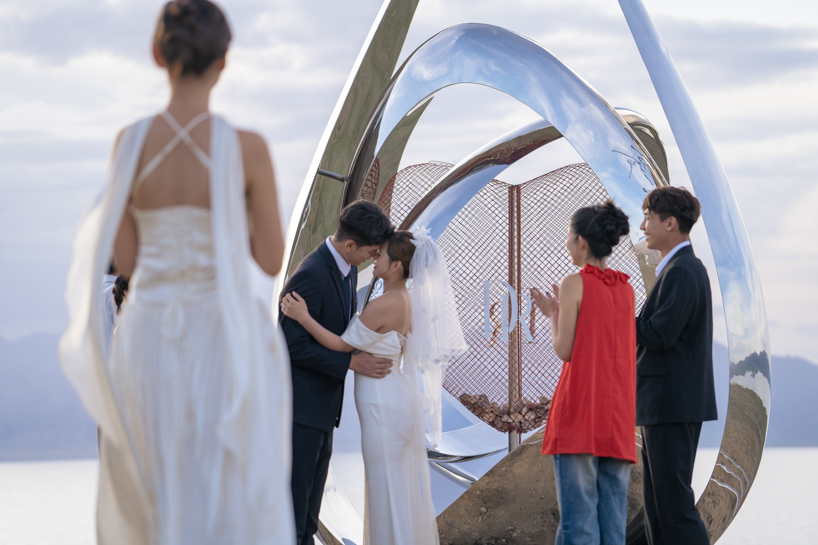 a mirrored water drop installation reflects the landscape of sayram lake in china - 8