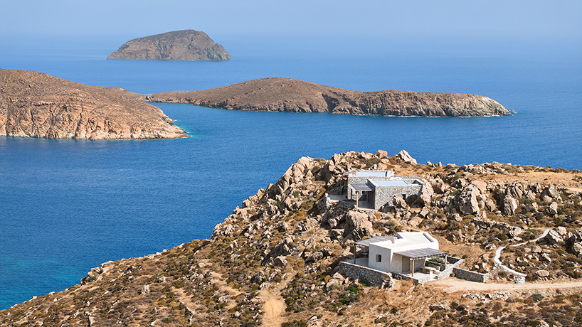 exposed stone masonry fuses restored residence by c-o lab with greek island's rocky terrain